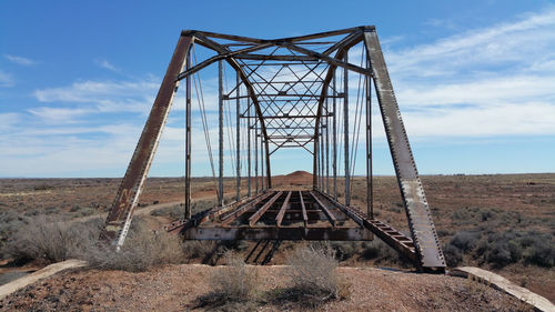 Abandoned bridge against landscape