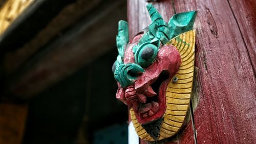 Close-up of animal representation on wooden pole