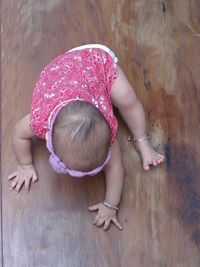 High angle view of toddler on hardwood floor at home