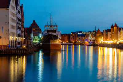 Gdansk night city riverside view with moored ship. poland.