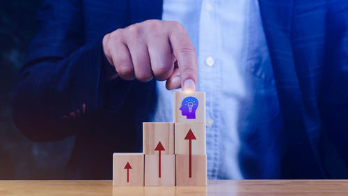 Midsection of businessman gesturing at table