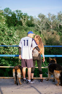 Active family, fitness couple, pet love, dog training, best dog breeds for family. young sports 