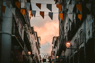 Low angle view of illuminated buildings against sky at sunset