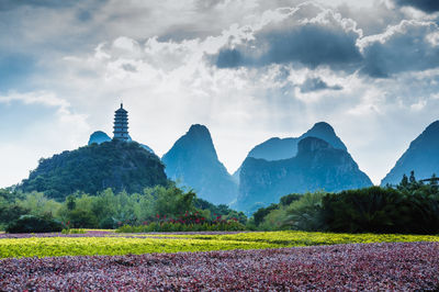 Scenic view of mountains against cloudy sky