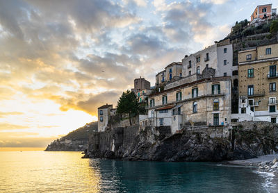 The typical village of minori overlooking the tyrrhenian sea at sunset, amalfi coast,  italy