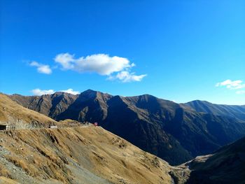 Scenic view of mountains against blue sky