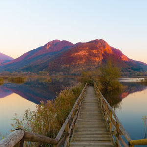 Scenic view of lake and mountains against clear sky