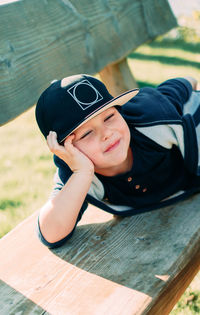 High angle portrait of boy wearing baseball cap