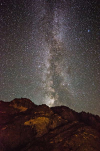 Scenic view of mountains against sky at night