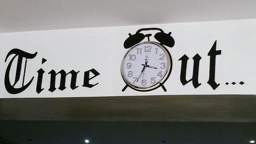 Low angle view of clock against sky