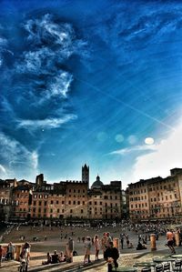 Buildings against cloudy sky