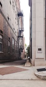 Empty alley amidst buildings in city