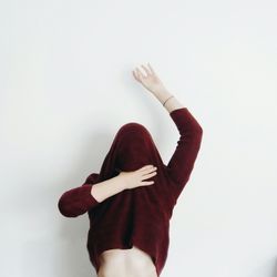 Midsection of woman standing against white background