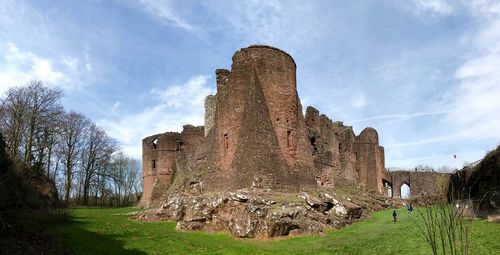 Old ruin building on field against sky