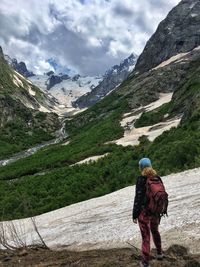 Full length of man on snow covered mountains against sky