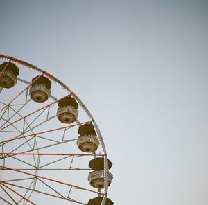 Cropped image of ferris wheel against clear sky