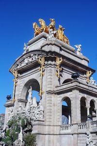 Low angle view of historic building against clear blue sky