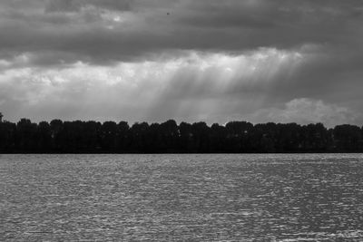 Scenic view of sea against storm clouds