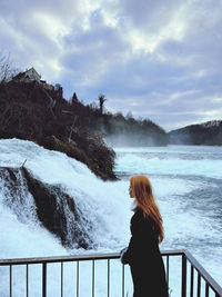 Woman looking at waterfall