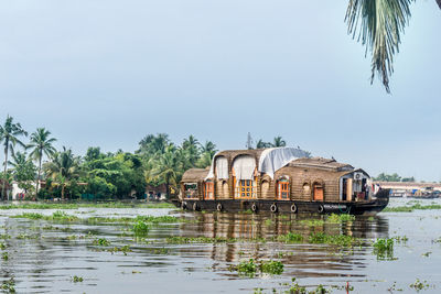 Built structure by lake against sky