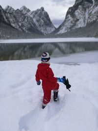 Boy in snow against mountain