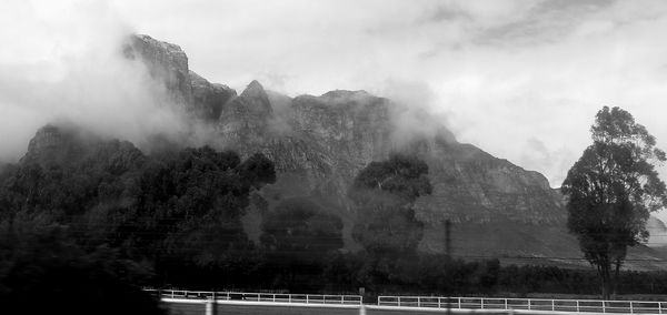 Panoramic view of mountains against cloudy sky