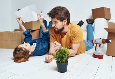 People sitting on paper at home