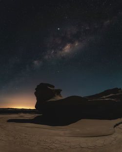 Scenic view of desert against sky at night