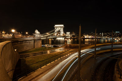 View of bridge over river at night