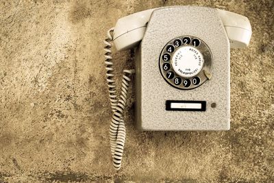 Close-up of telephone hanging on wall