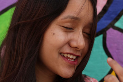 Close-up portrait of a smiling young woman