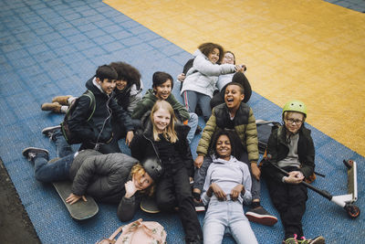 High angle view of diverse school students relaxing in sports court