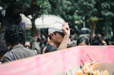 Rear view of people against blurred background