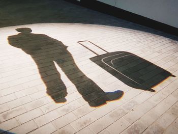 High angle view of shadow on tiled floor