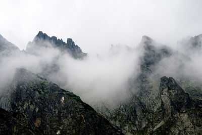 View of rock mountains amidst smoke