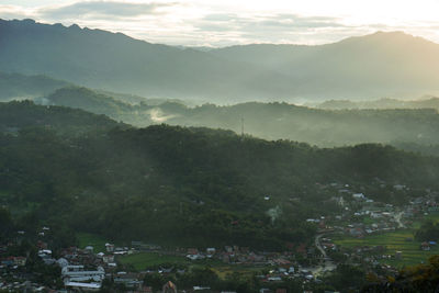 High angle view of trees and mountains against sky