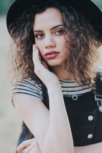 Portrait of beautiful young woman standing outdoors