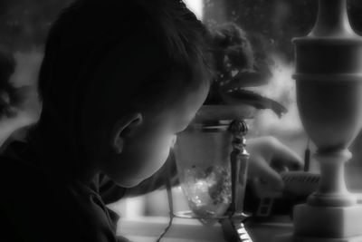 Close-up portrait of boy drinking water from glass