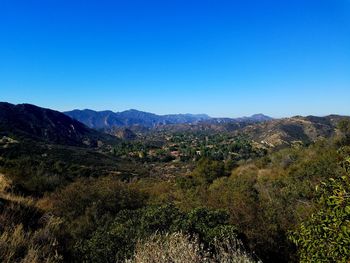 Scenic view of mountains against clear blue sky