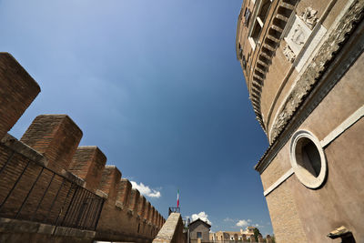 Low angle view of buildings against blue sky