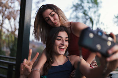 Lesbian couple taking selfie in balcony