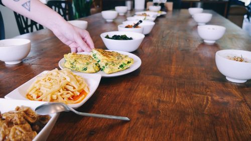 Midsection of person having food on table