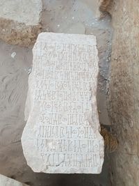 High angle view of text on stone