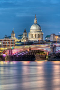 Illuminated bridge against sky in city