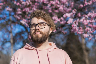 Portrait of young man against trees