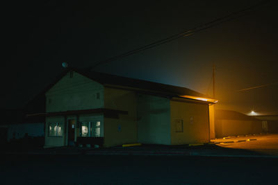 Illuminated building against sky at night