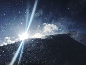 Scenic view of mountain against sky at night