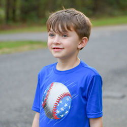 Portrait of boy with ball while standing outdoors