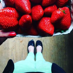 Low section of person with strawberries