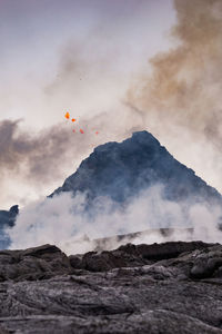 Scenic view of volcanic mountain against sky